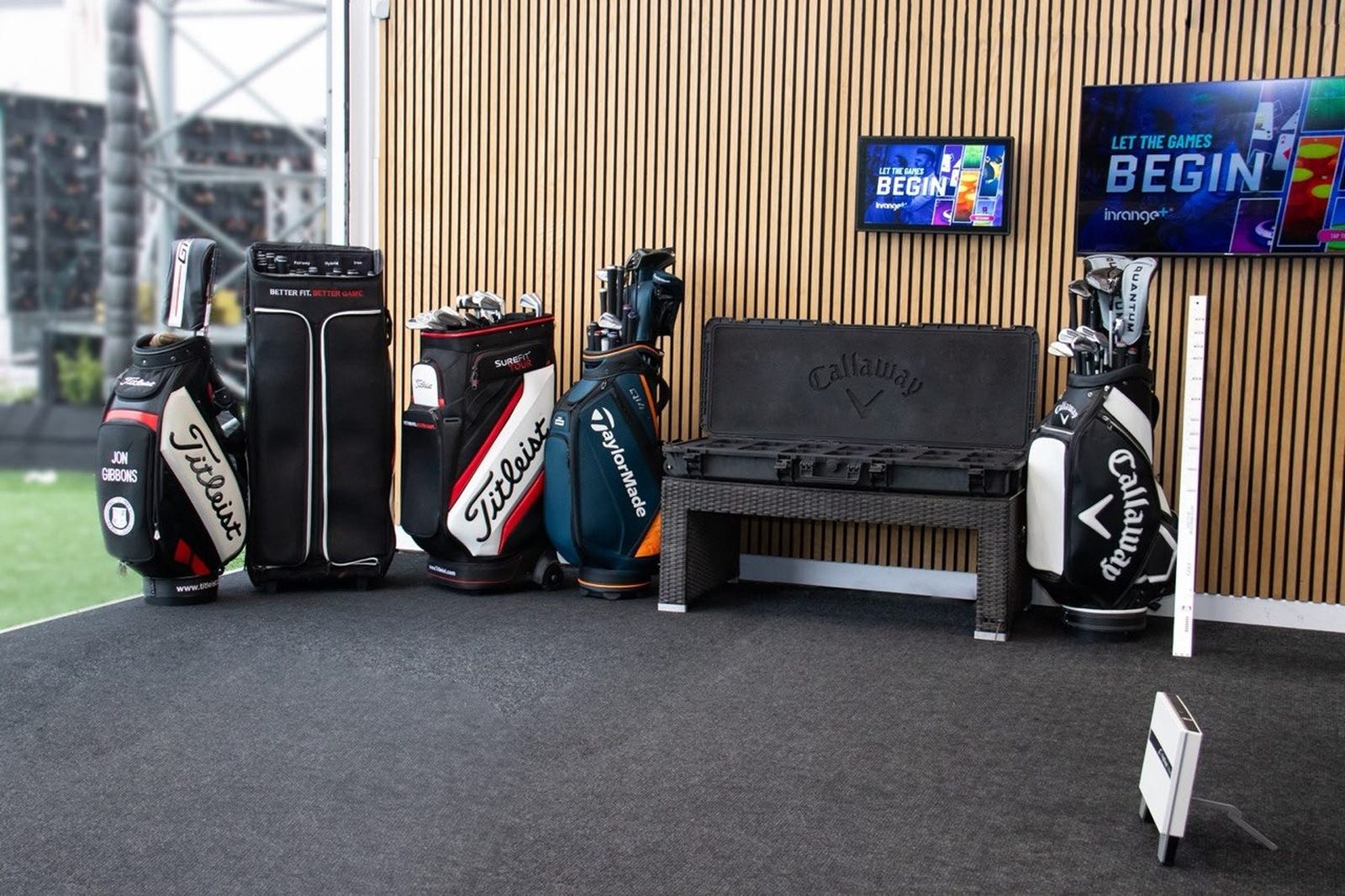 Fitting bags and a club case in a bay at the range, including Jon Gibbons' bag