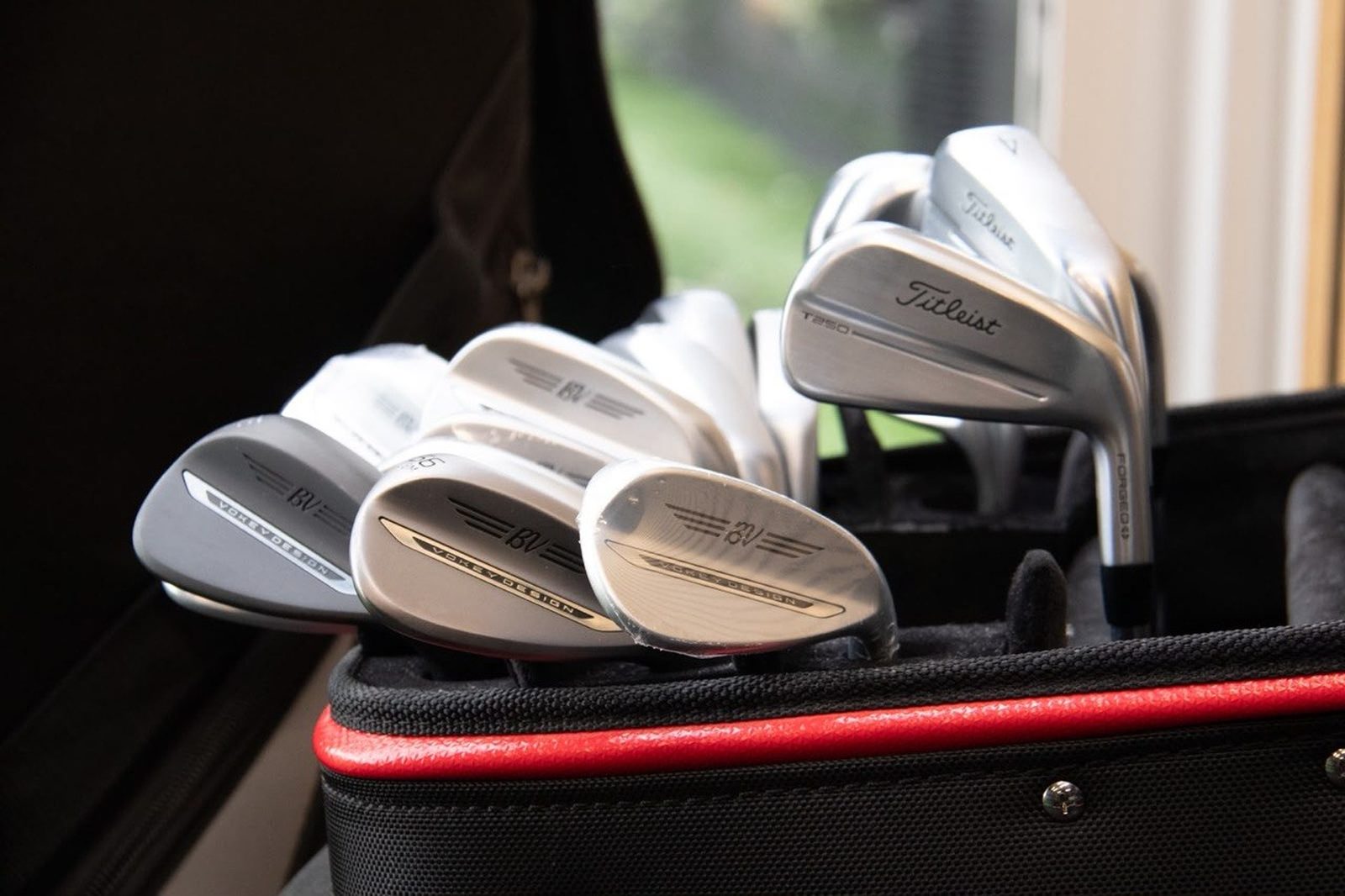 Vokey wedges and a Titleist iron in a golf bag