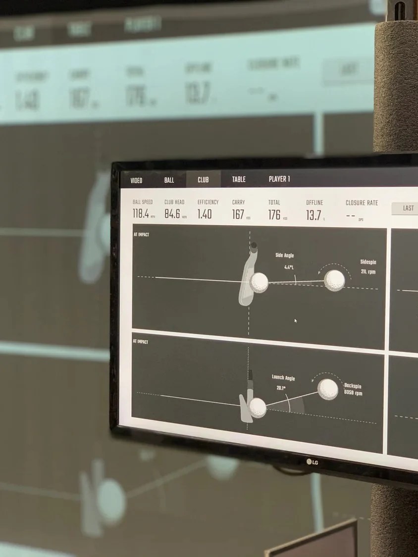 Launch monitor screen showing ball speed, carry, and impact